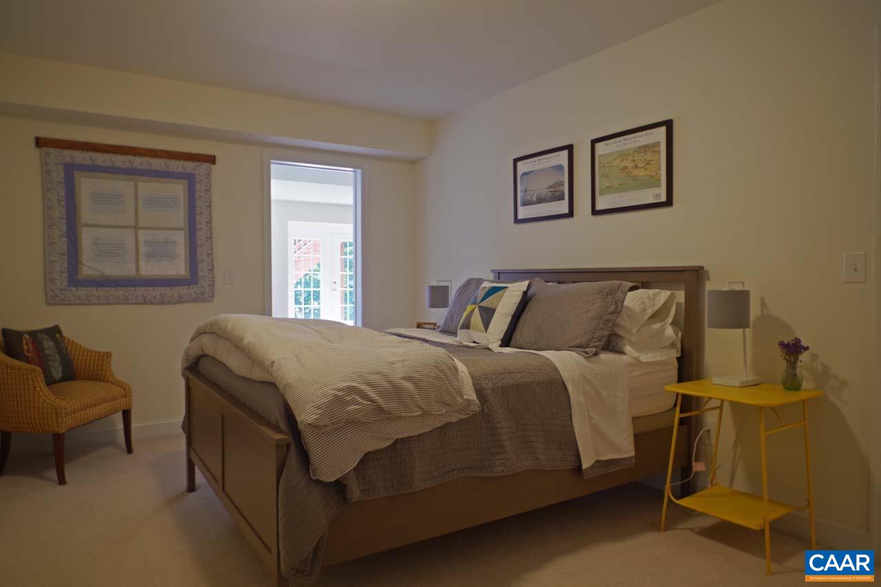 2059 Ridgetop Drive Charlottesville, VA 22903 - Photo 60 of 68 a bed sitting in a bedroom next to a window and a couch