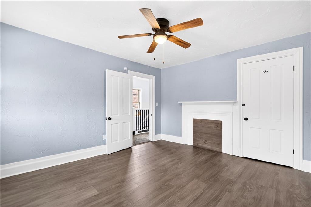 101 7th Street Monongahela, PA 15063 - Photo 27 of 43 an empty room with wooden floor ceiling fan and windows