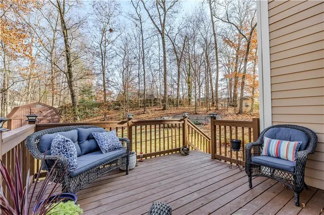 a balcony with furniture and wooden floor