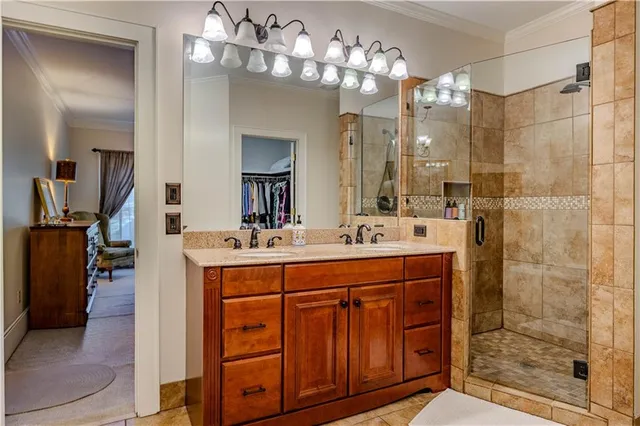 a bathroom with a double vanity sink mirror and shower