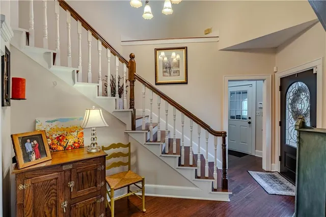 a view of entryway with wooden floor and stairs