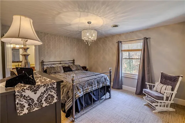 a bed room with a bed and a chair