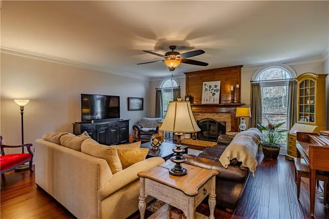 a living room with furniture a fireplace and a flat screen tv