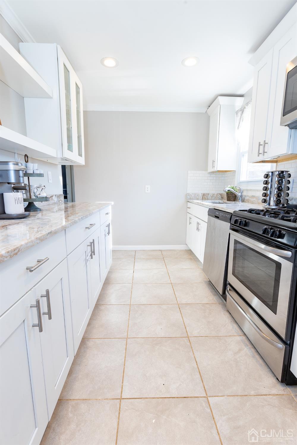 125 Tunison Road New Brunswick, NJ 08901 - Photo 20 of 24 a kitchen with a stove top oven sink and cabinets