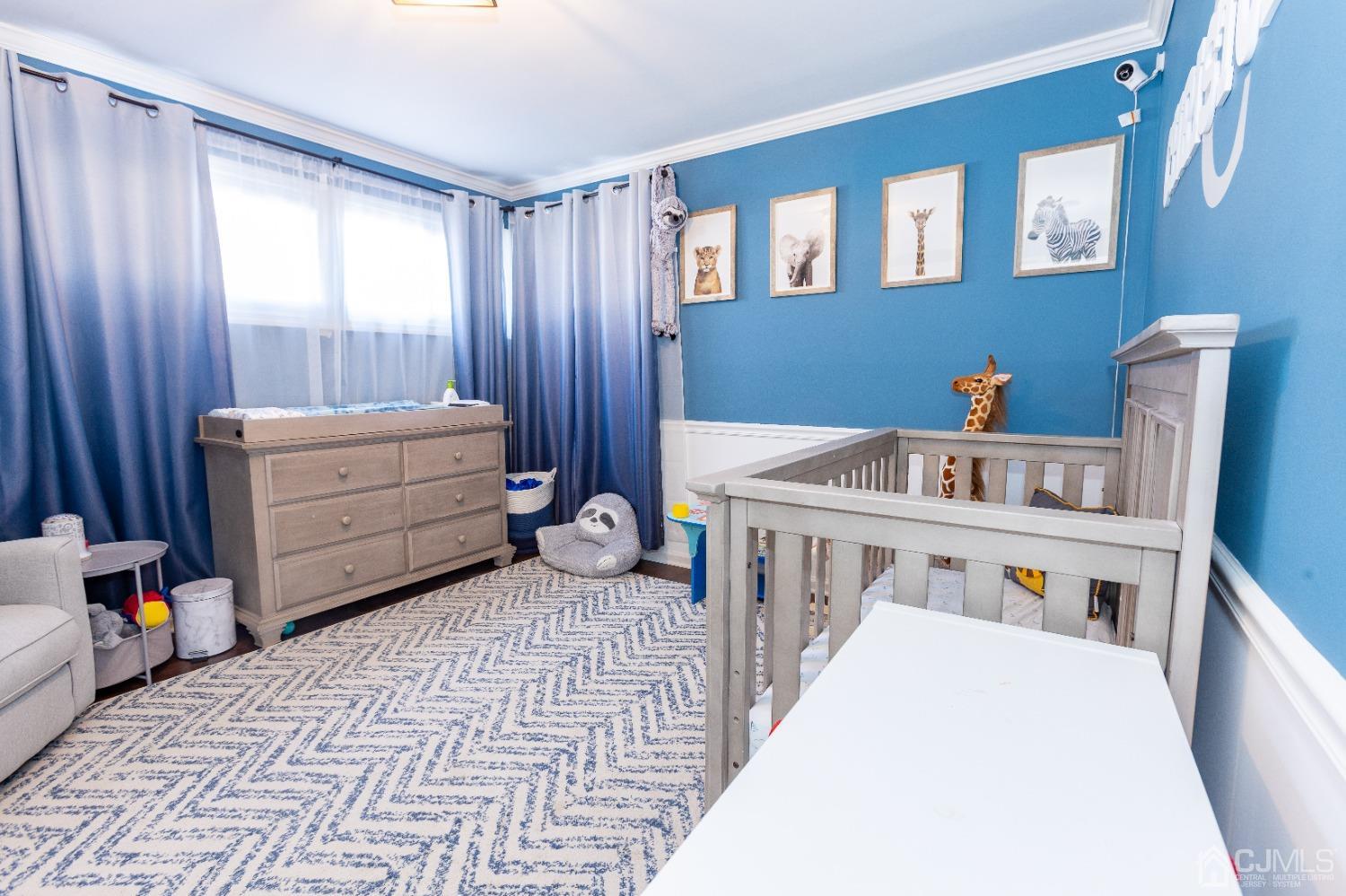 125 Tunison Road New Brunswick, NJ 08901 - Photo 5 of 24 a bedroom with furniture and a baby crib