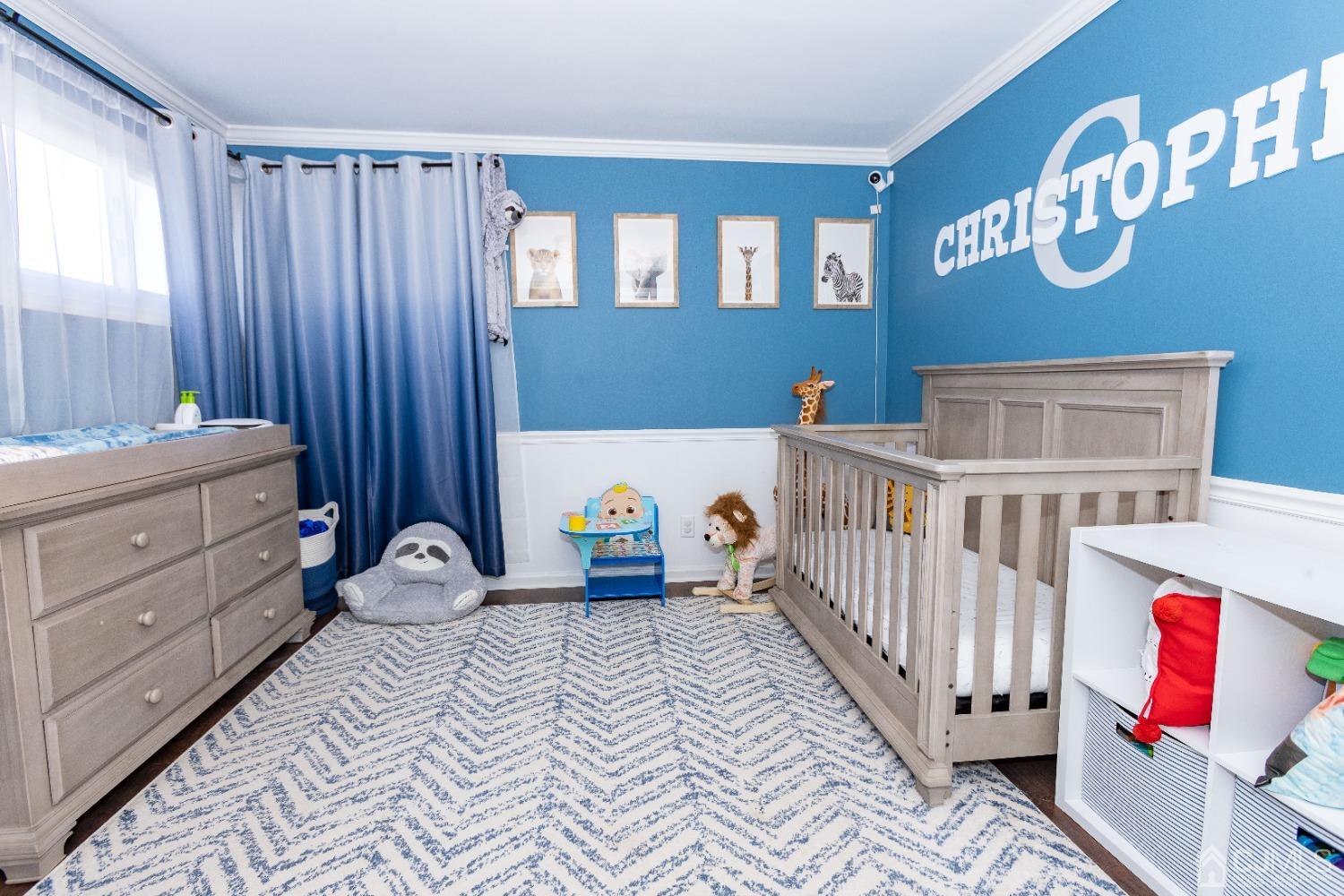 125 Tunison Road New Brunswick, NJ 08901 - Photo 7 of 24 a bedroom with baby bed and a window