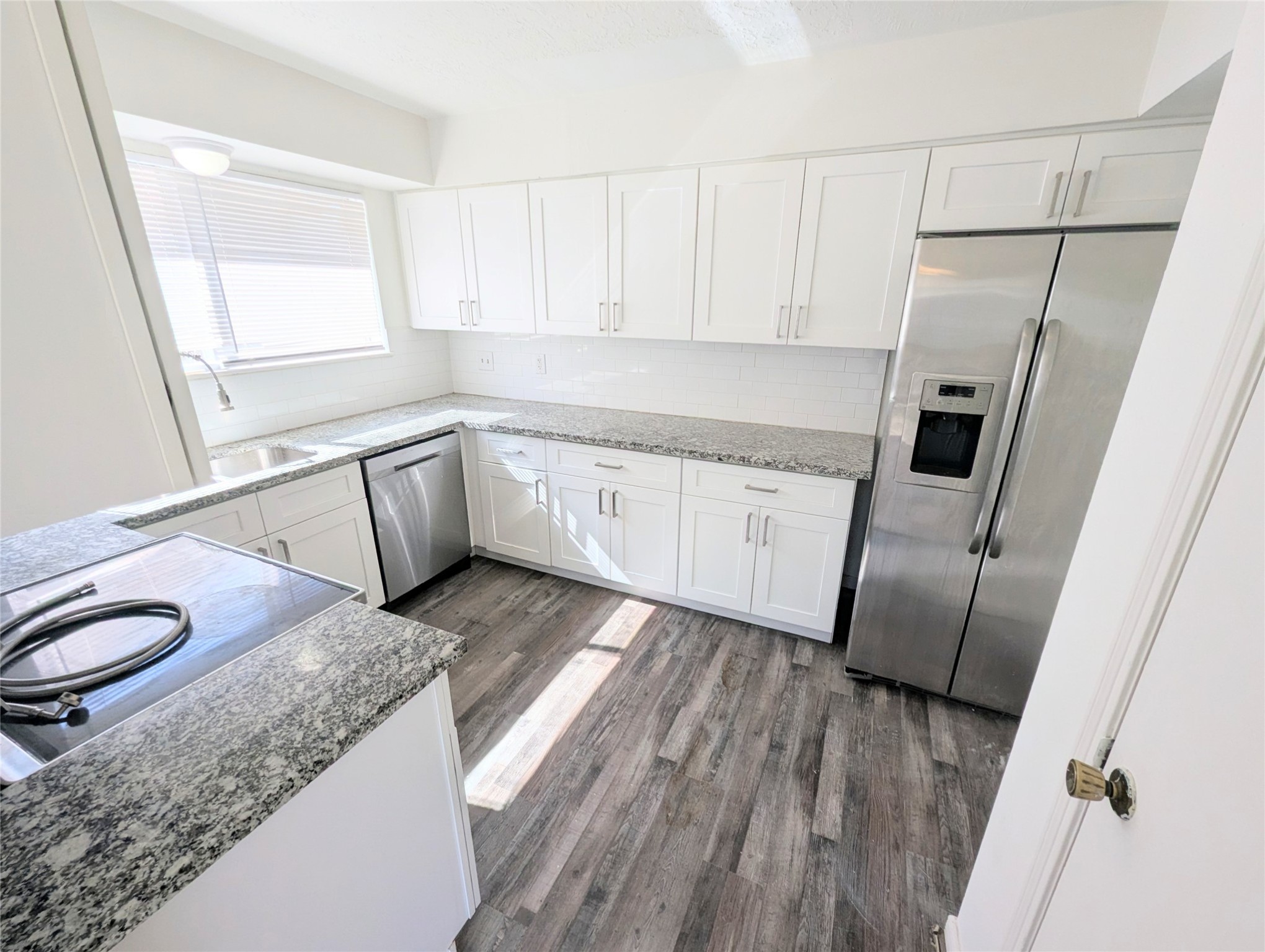17602 Crestline Road Humble, TX 77396 - Photo 4 of 25 a kitchen with a sink a refrigerator a window and cabinets