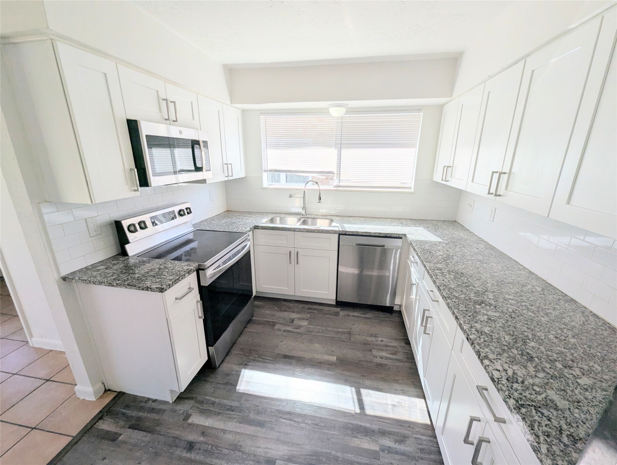 17602 Crestline Road Humble, TX 77396 - Photo 5 of 25 a kitchen with stainless steel appliances granite countertop a sink stove and cabinets