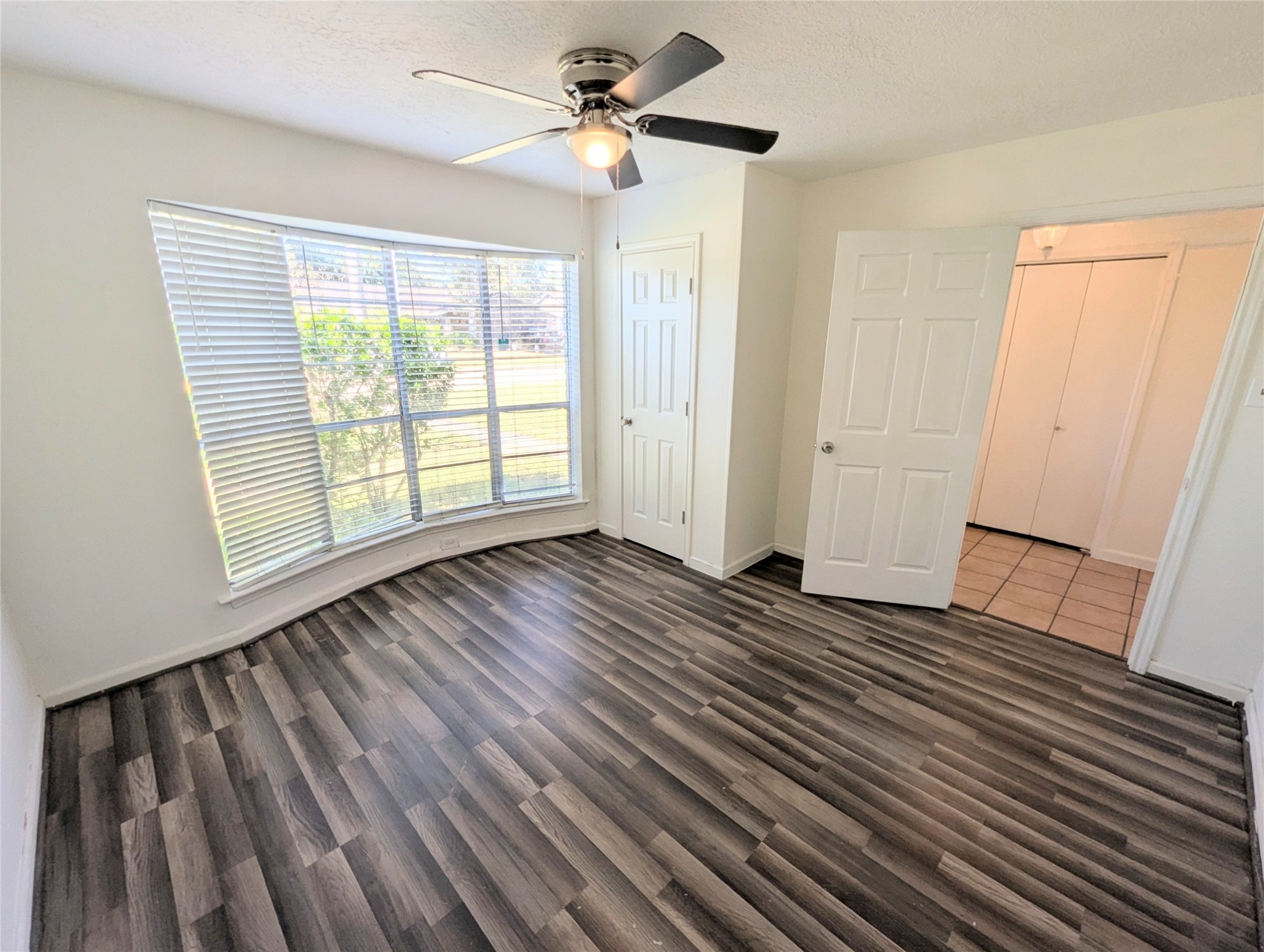 17602 Crestline Road Humble, TX 77396 - Photo 7 of 25 a view of an empty room with wooden floor and a window
