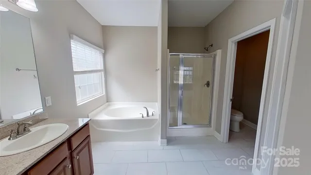 a bathroom with a tub sink and mirror