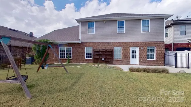 a view of a house with backyard porch and sitting area