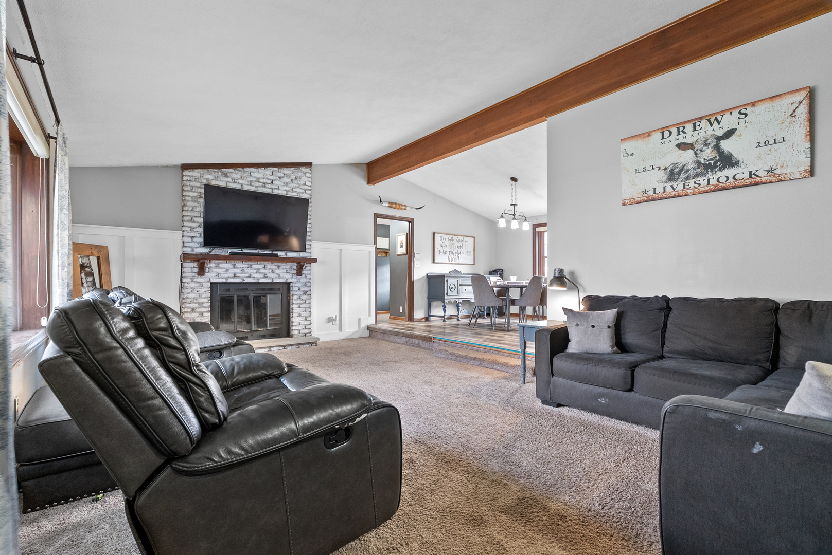 27440 Highway 52 Manhattan, IL 60442 - Photo 26 of 50 a living room with furniture a flat screen tv and a fireplace