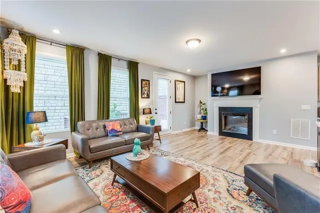 a living room with furniture fireplace and window