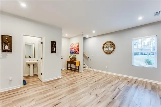 a view of a room with wooden floor and window