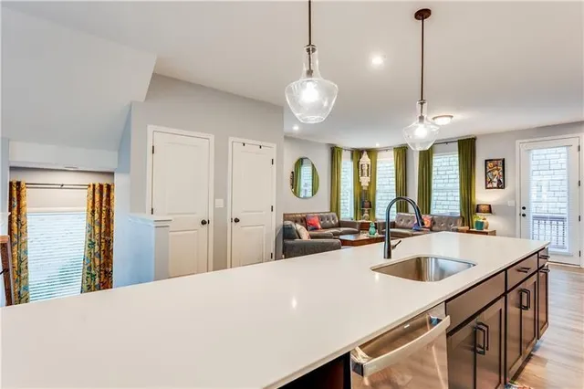 a kitchen with a stove a sink and a refrigerator