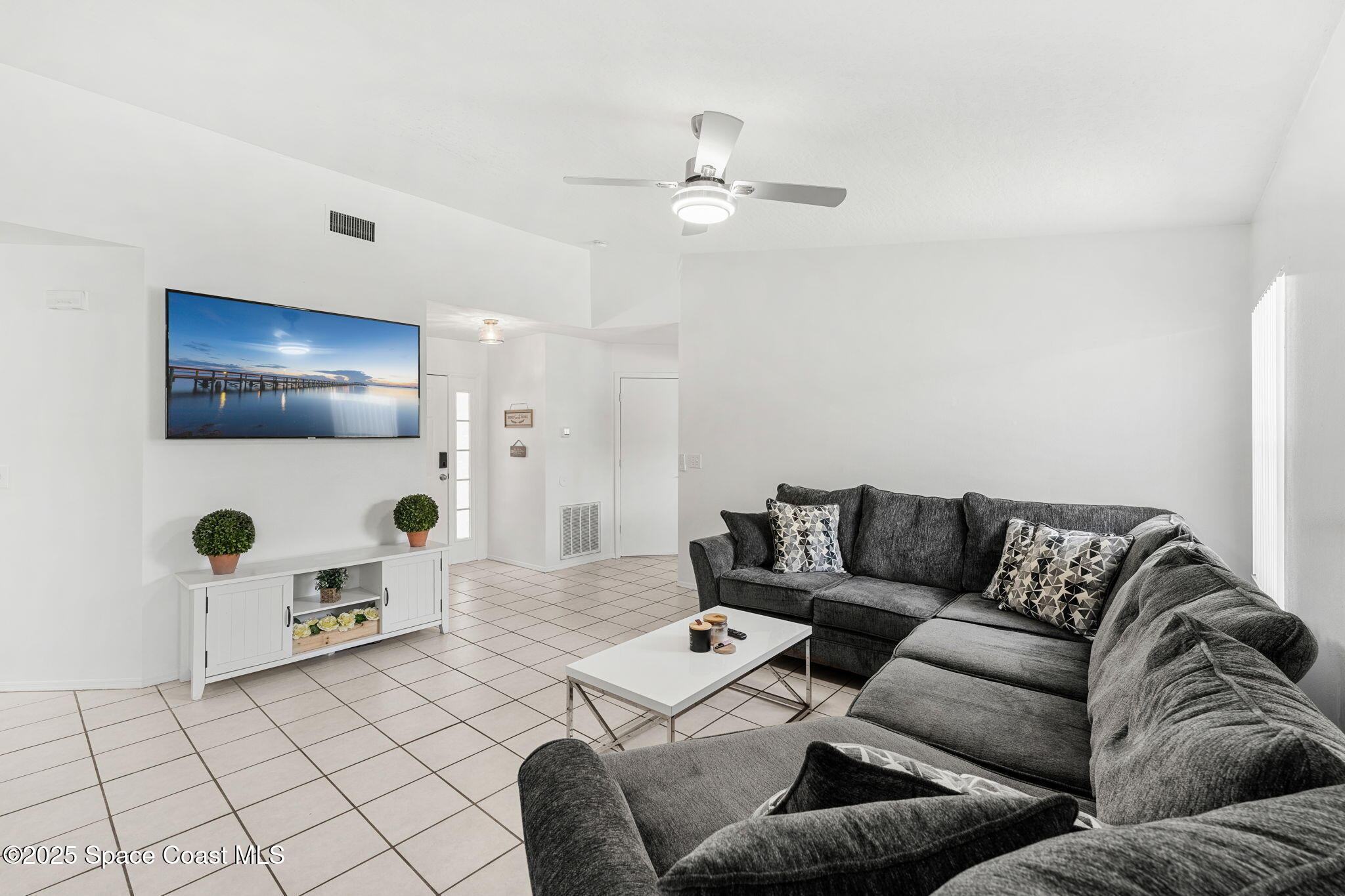 1157 Goldenrod Circle Northeast Palm Bay, FL 32905 - Photo 11 of 31 a living room with furniture and a flat screen tv