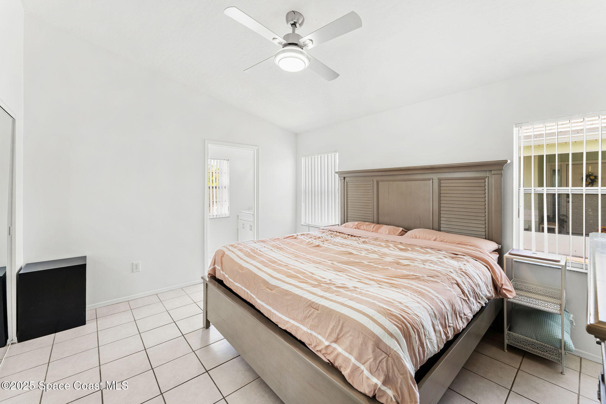 1157 Goldenrod Circle Northeast Palm Bay, FL 32905 - Photo 15 of 31 a bedroom with a bed and a window