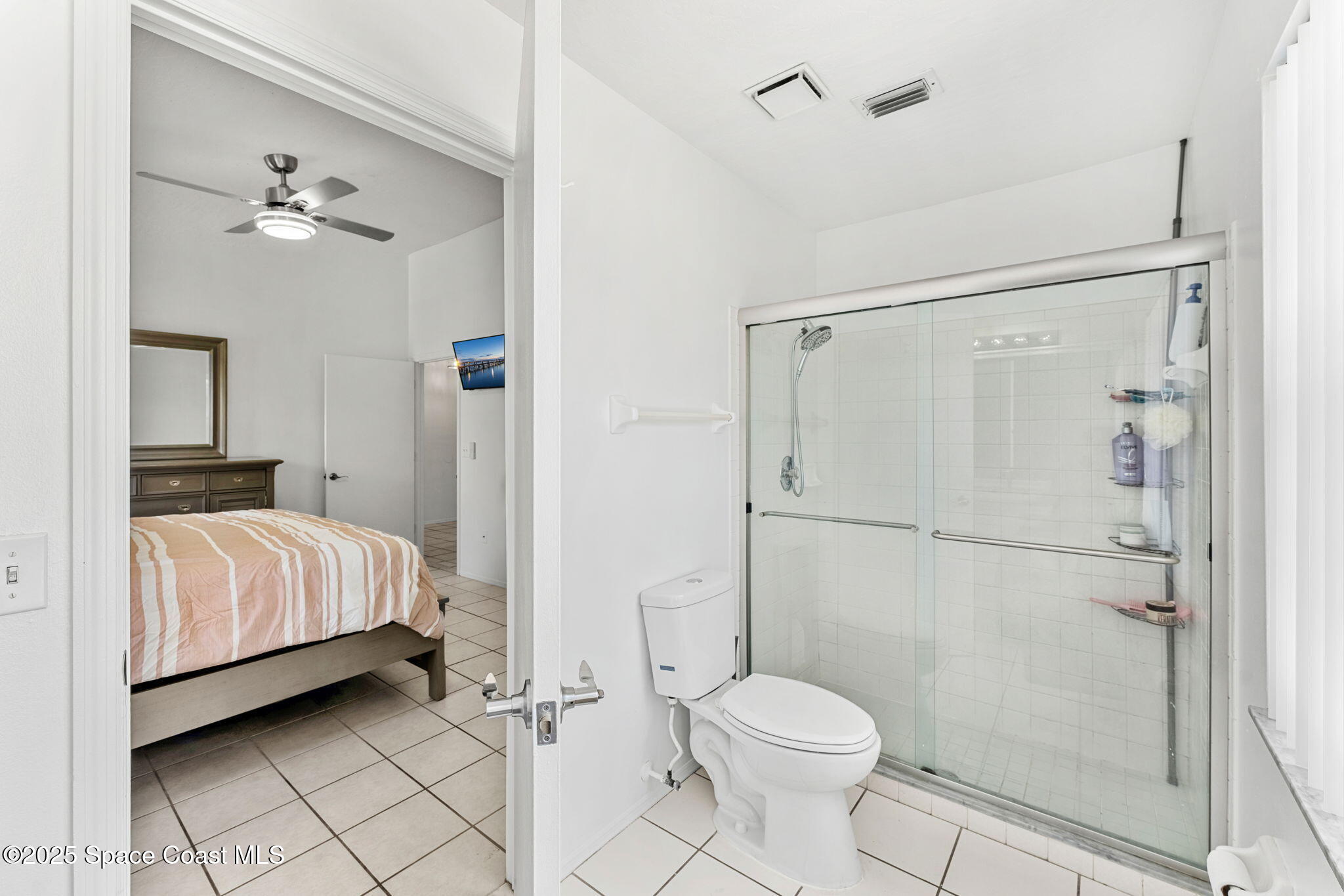 1157 Goldenrod Circle Northeast Palm Bay, FL 32905 - Photo 16 of 31 a bedroom with a bed and a shower