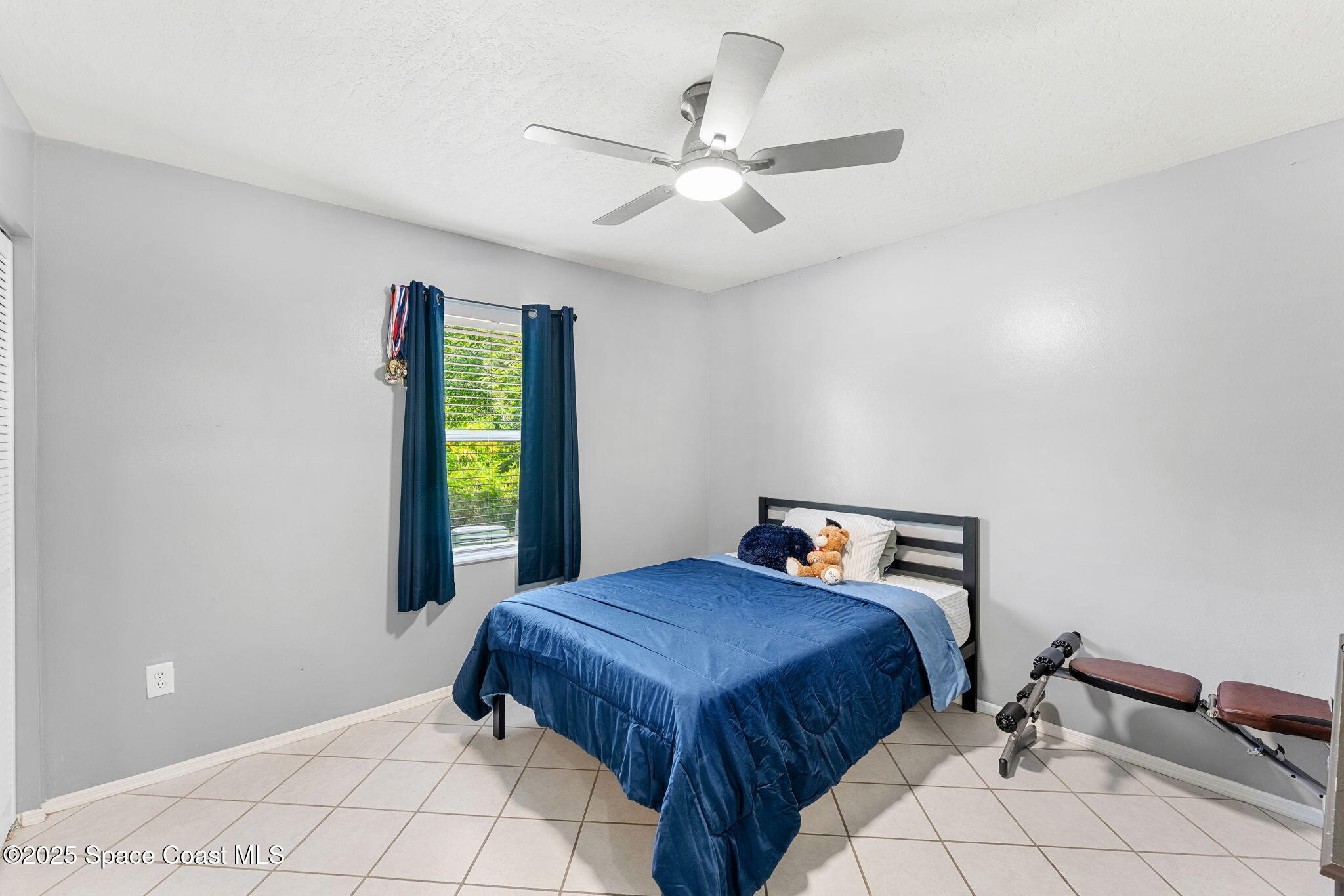 1157 Goldenrod Circle Northeast Palm Bay, FL 32905 - Photo 18 of 31 a bedroom with a bed and window