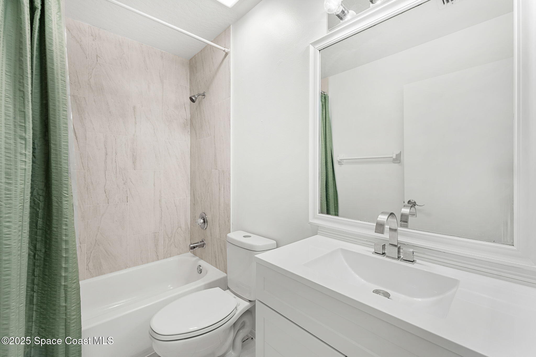 1157 Goldenrod Circle Northeast Palm Bay, FL 32905 - Photo 19 of 31 a bathroom with a toilet a sink and a bathtub