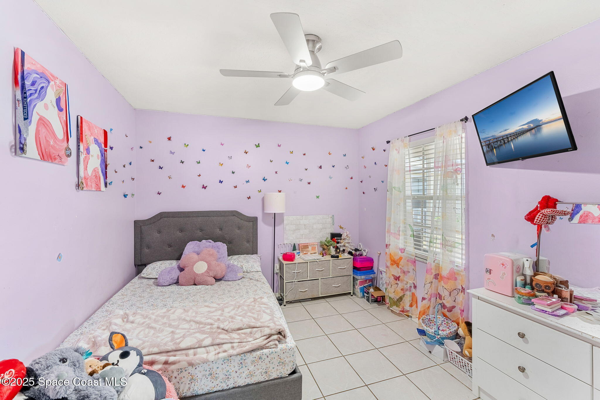 1157 Goldenrod Circle Northeast Palm Bay, FL 32905 - Photo 20 of 31 a bedroom with a bed and a window