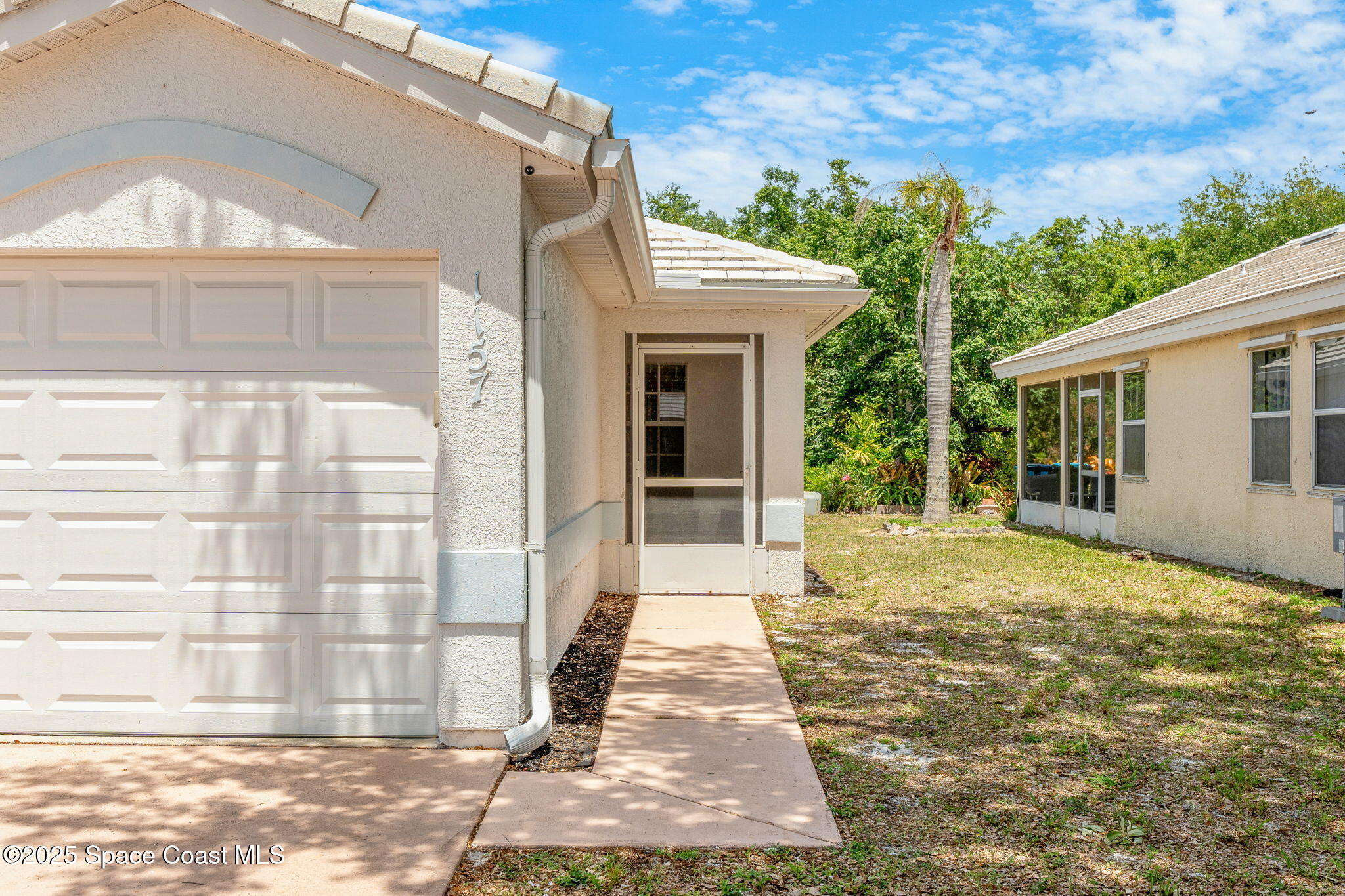 1157 Goldenrod Circle Northeast Palm Bay, FL 32905 - Photo 2 of 31 a front view of a house with a yard