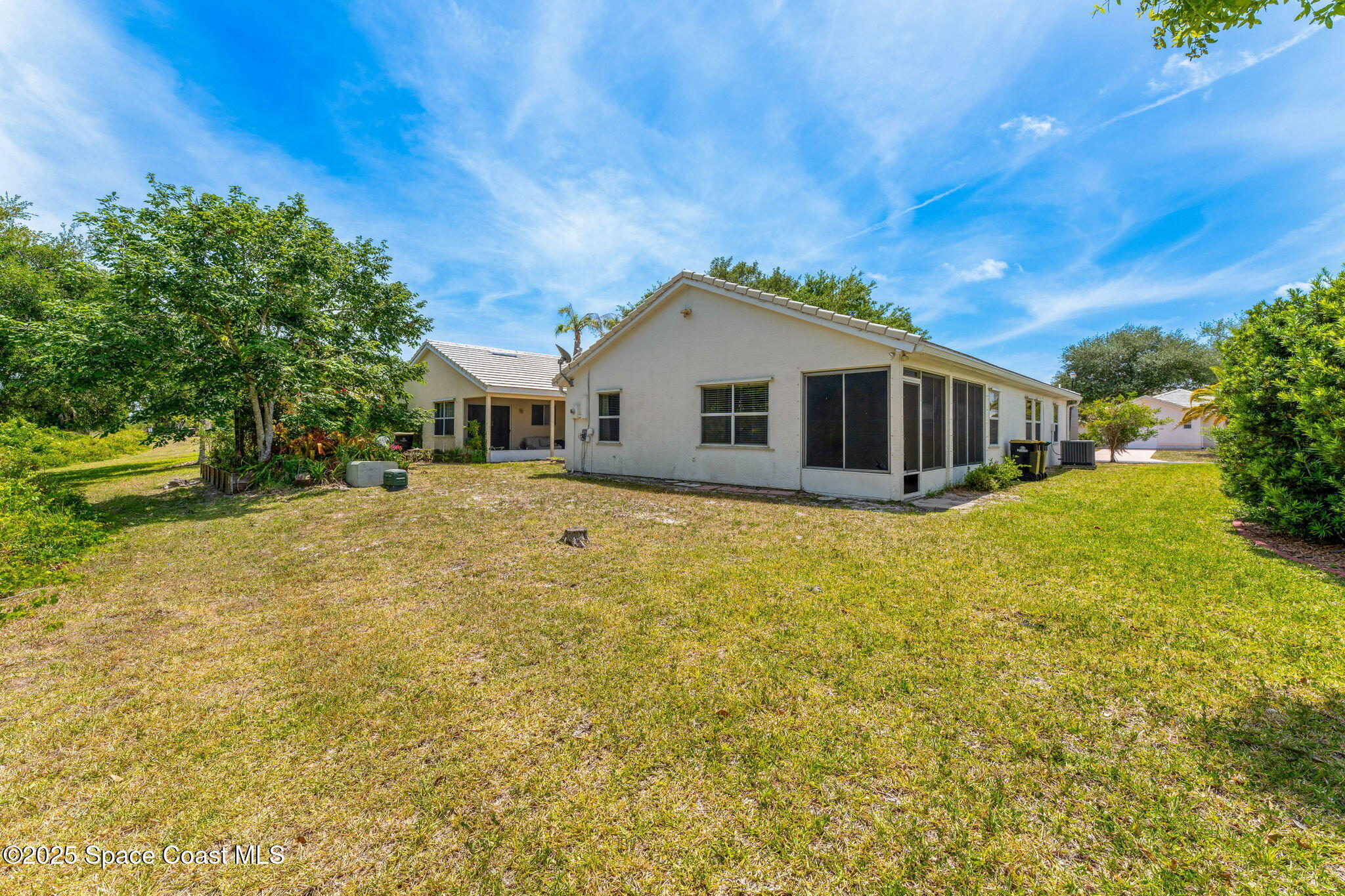 1157 Goldenrod Circle Northeast Palm Bay, FL 32905 - Photo 21 of 31 a front view of a house with a garden