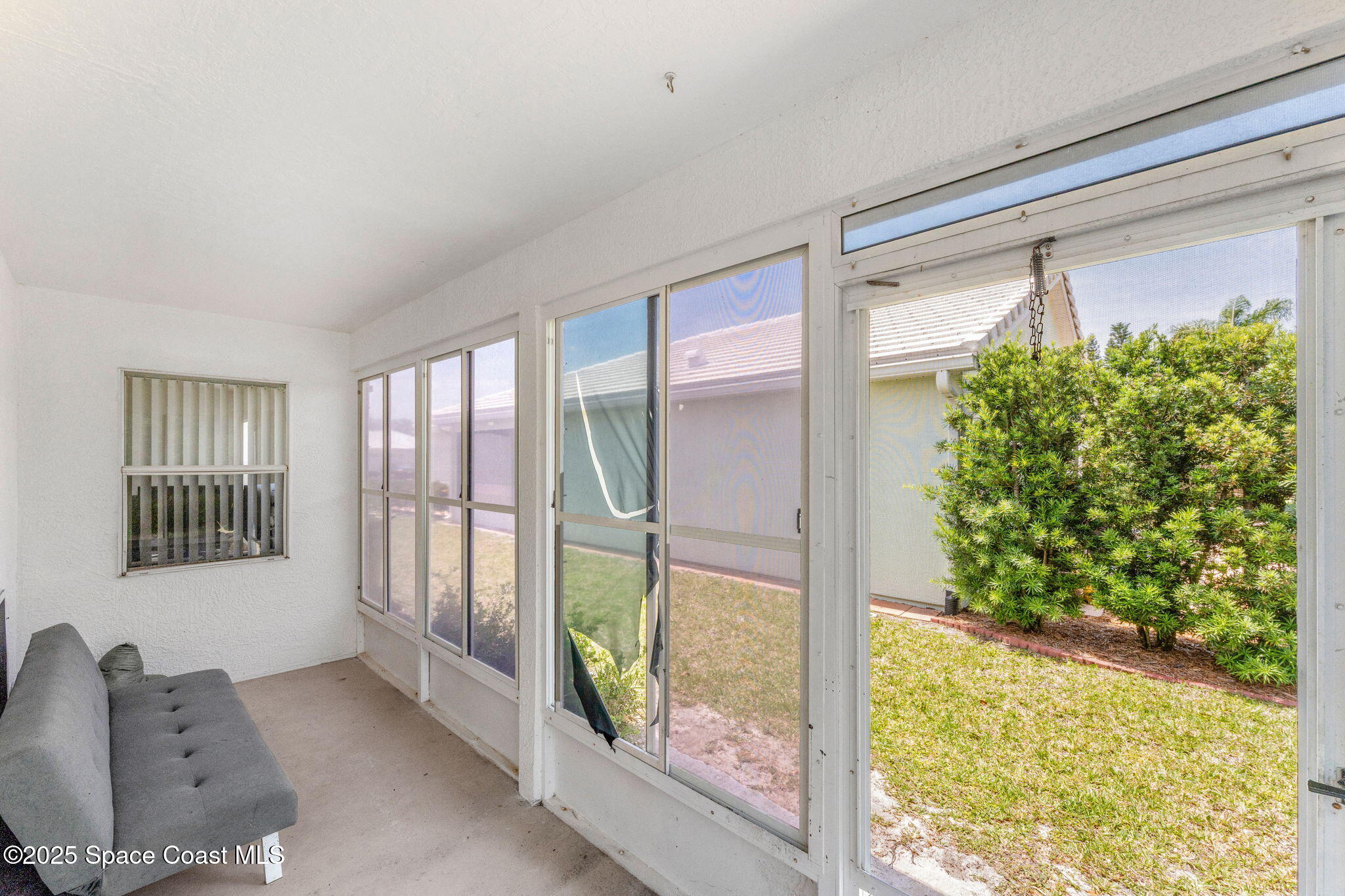 1157 Goldenrod Circle Northeast Palm Bay, FL 32905 - Photo 23 of 31 a view of an entryway with a floor to ceiling window and wooden floor