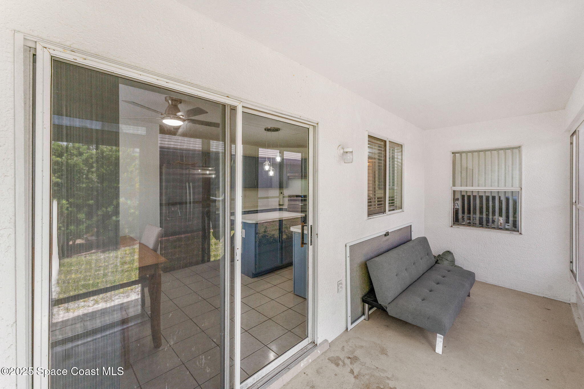 1157 Goldenrod Circle Northeast Palm Bay, FL 32905 - Photo 24 of 31 a living room with furniture and a glass door