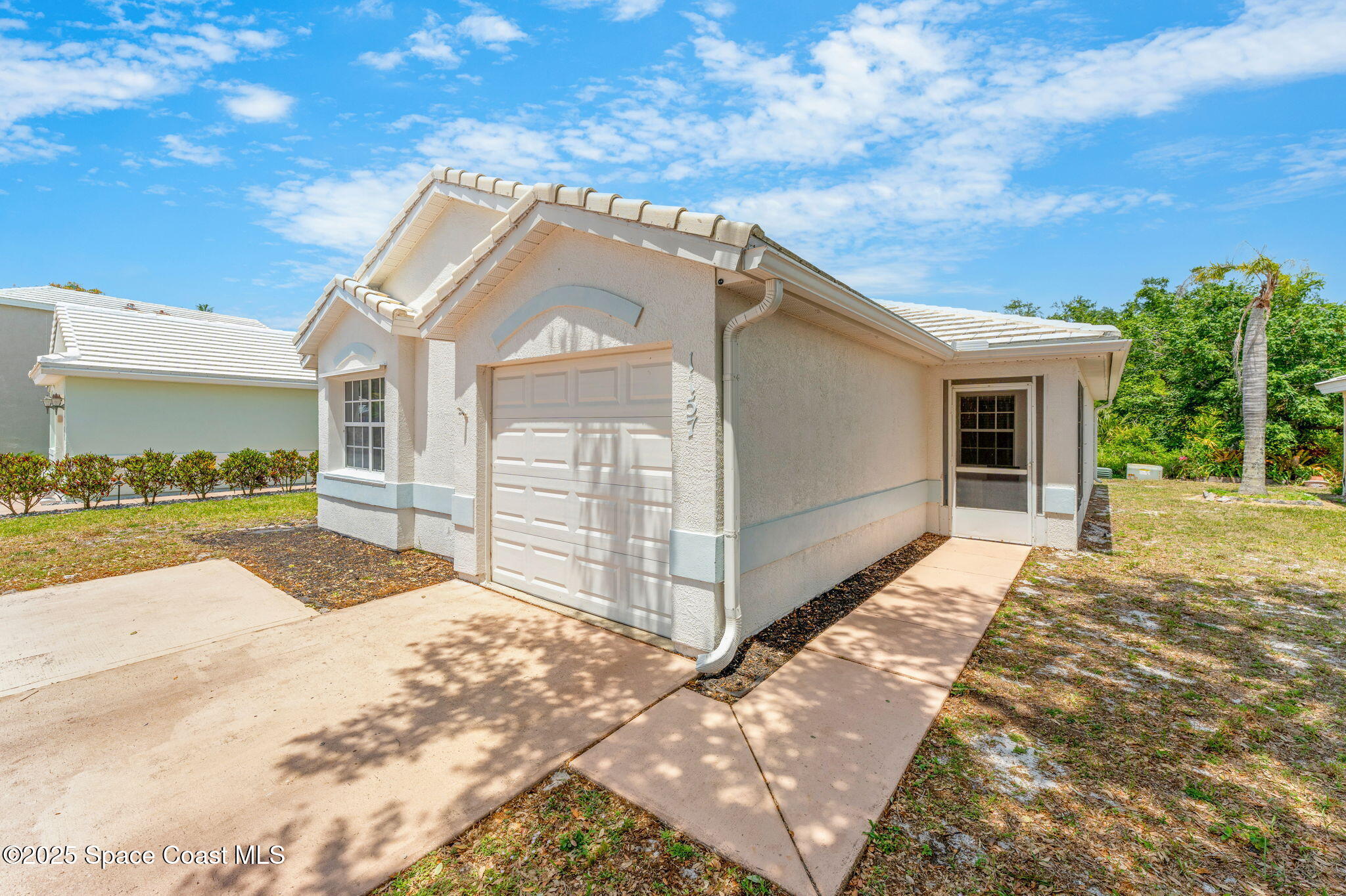 1157 Goldenrod Circle Northeast Palm Bay, FL 32905 - Photo 28 of 31 a view of a house with a yard