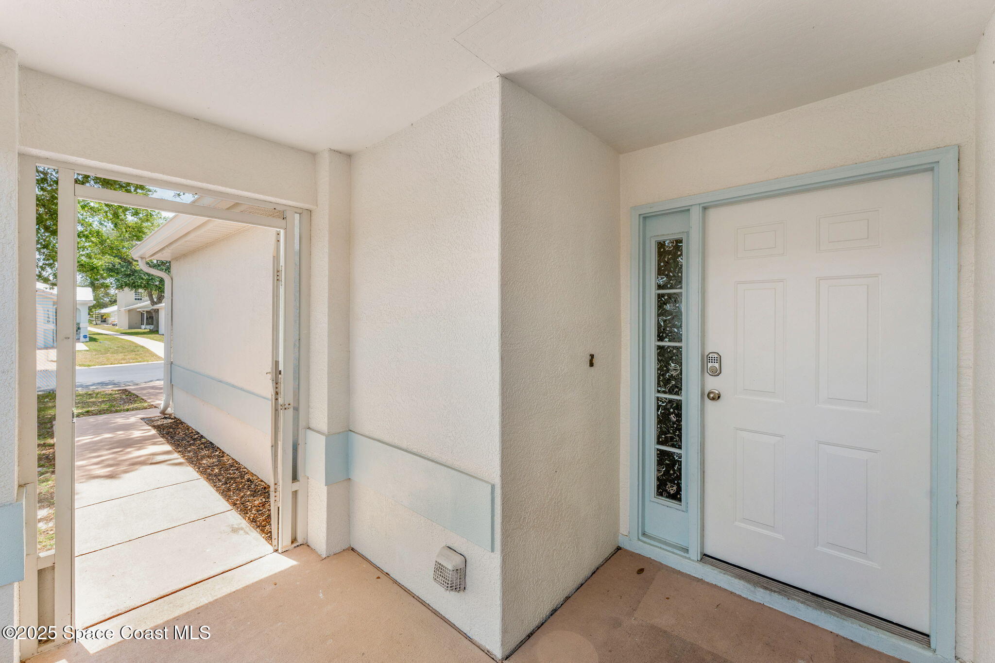 1157 Goldenrod Circle Northeast Palm Bay, FL 32905 - Photo 3 of 31 a view of a hallway with wooden floor and entryway