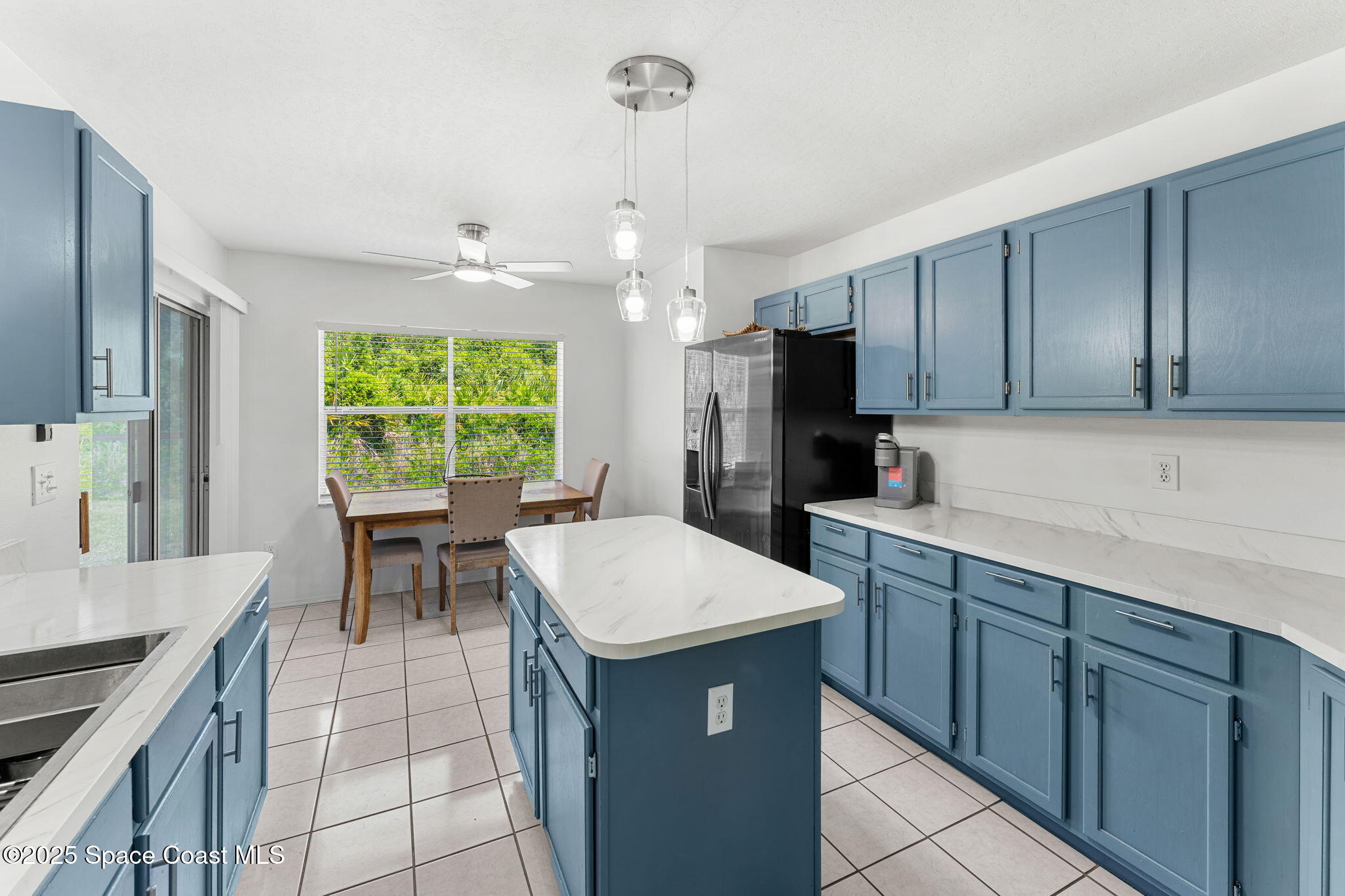 1157 Goldenrod Circle Northeast Palm Bay, FL 32905 - Photo 5 of 31 a kitchen with a stove a sink and a refrigerator