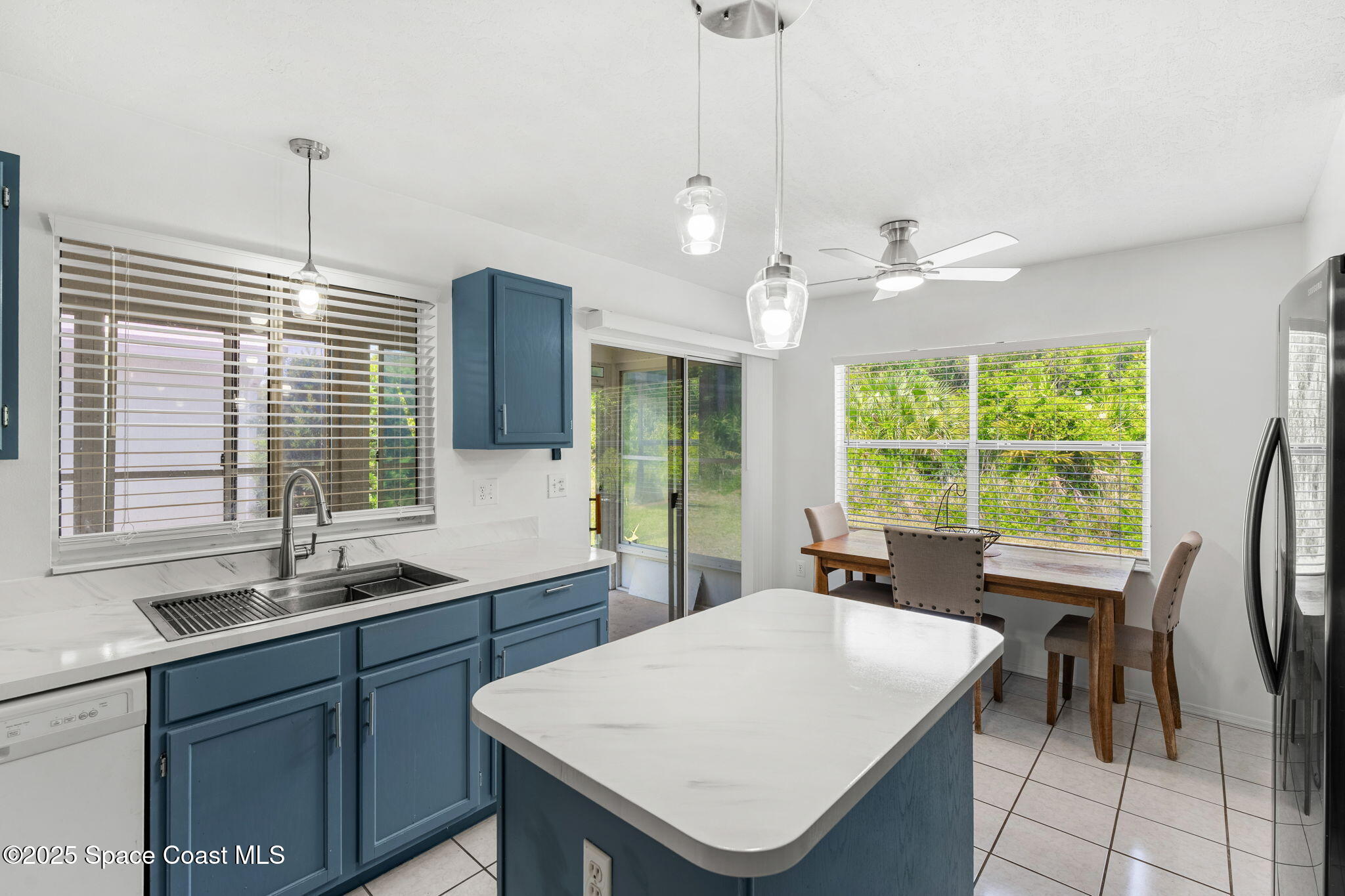 1157 Goldenrod Circle Northeast Palm Bay, FL 32905 - Photo 7 of 31 a kitchen with a table chairs sink and cabinets