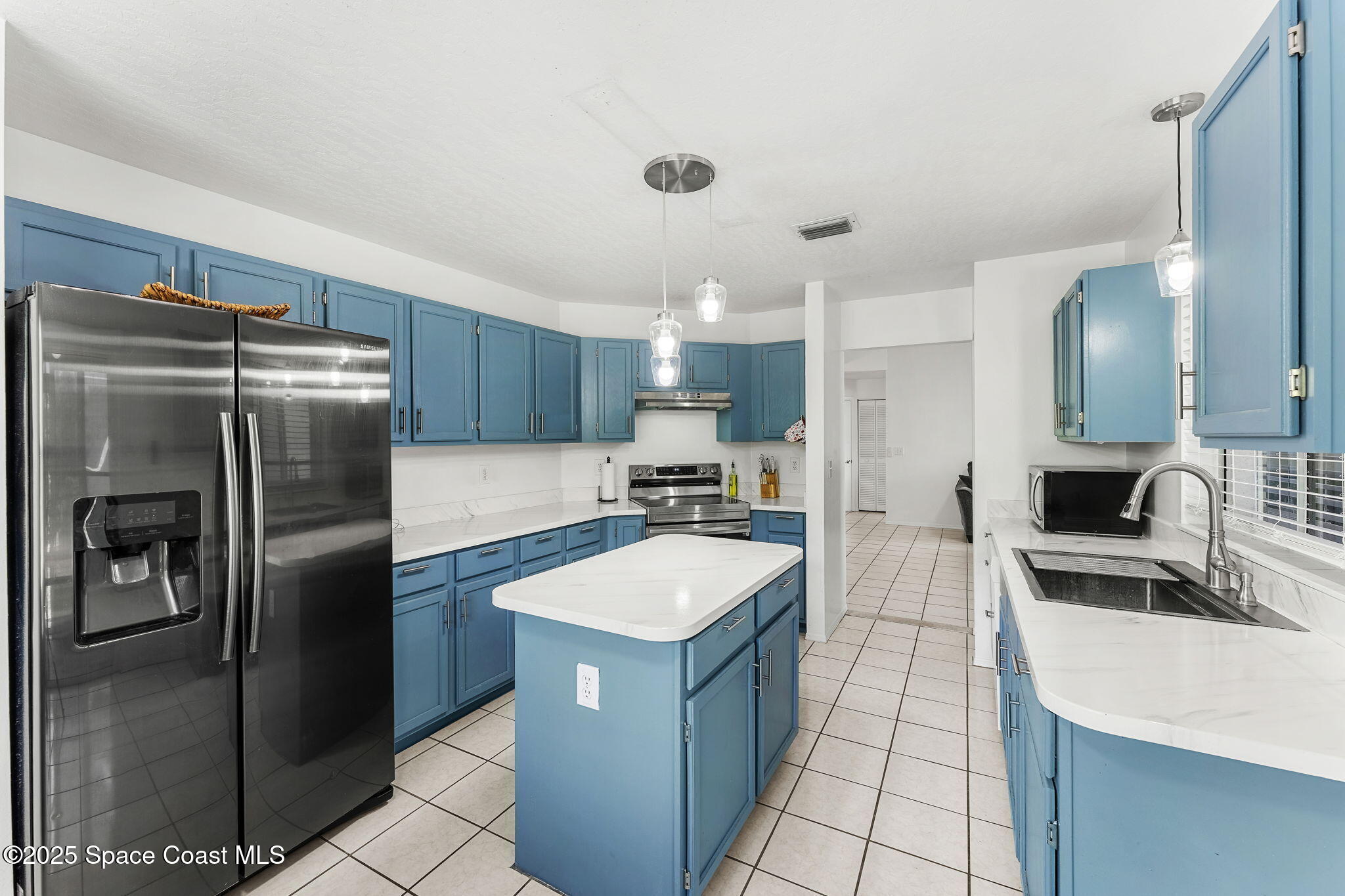 1157 Goldenrod Circle Northeast Palm Bay, FL 32905 - Photo 8 of 31 a kitchen with a refrigerator sink and stove