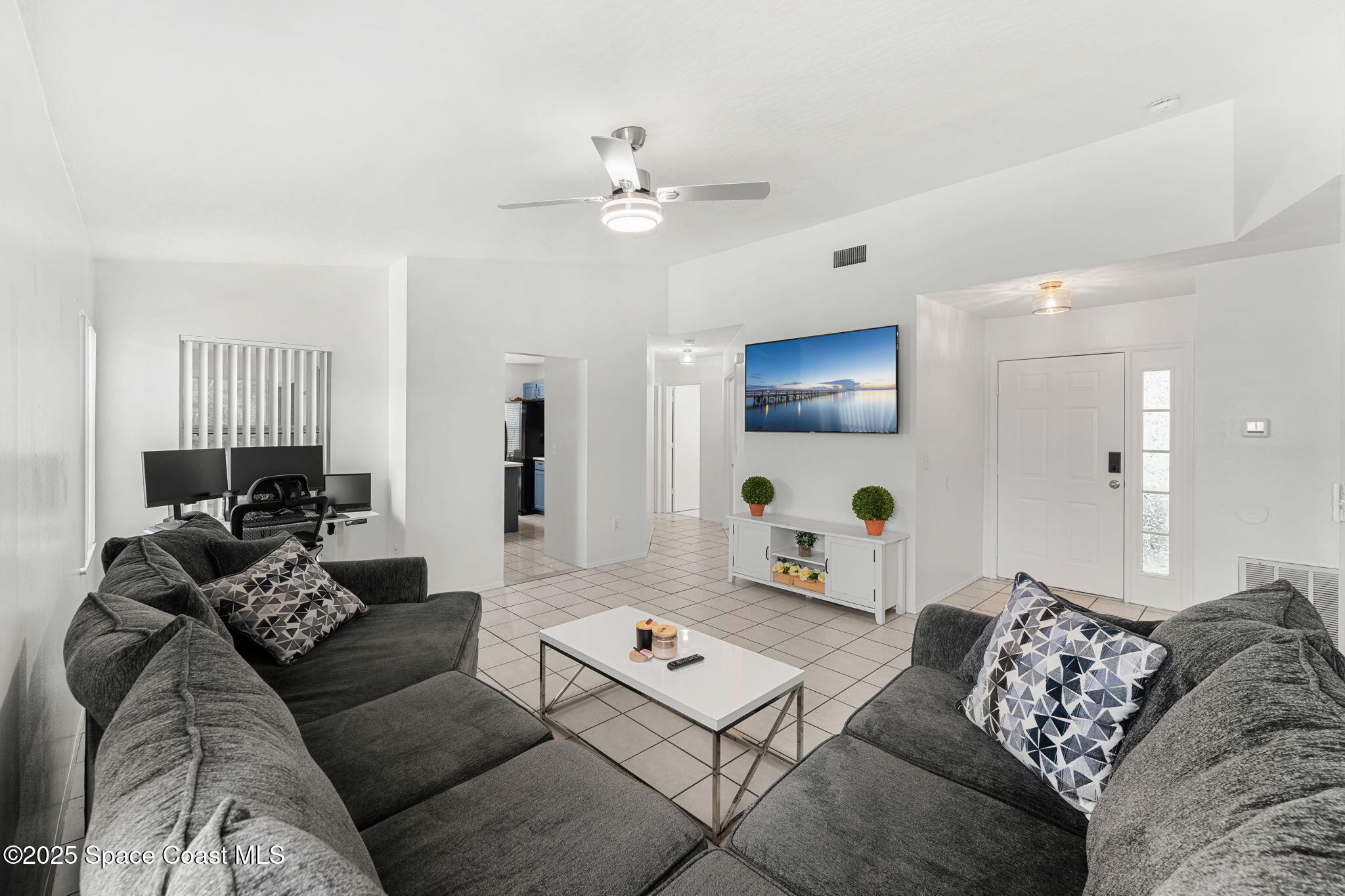1157 Goldenrod Circle Northeast Palm Bay, FL 32905 - Photo 10 of 31 a living room with furniture and a table
