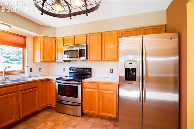 7808 Swiftrun Road Colorado Springs, CO 80920 - Photo 11 of 33 GE Profile Appliances stay with home, brand new sink and fixtures!