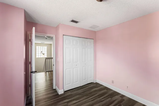 a view of a room with wooden floor and a window