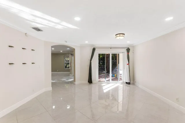 a view of a room with wooden floor and windows