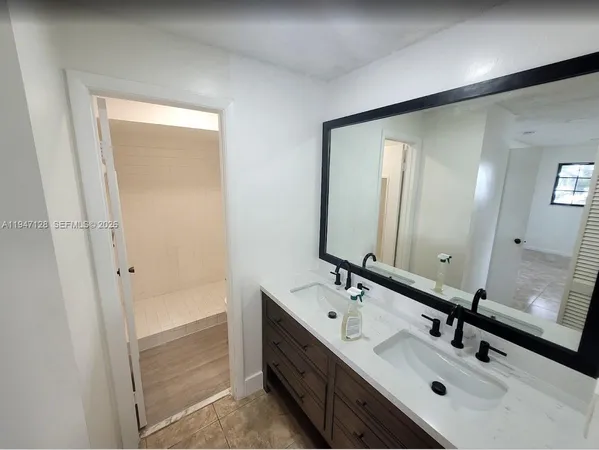 a bathroom with 2 sink and a mirror