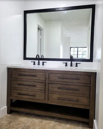 a bathroom with a sink and a mirror