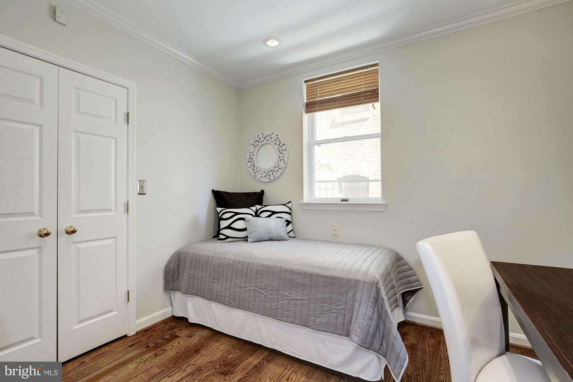 1806 Belmont Road Northwest, Unit 3 Washington, DC 20009 - Photo 12 of 21 a bedroom with a bed and wooden floor