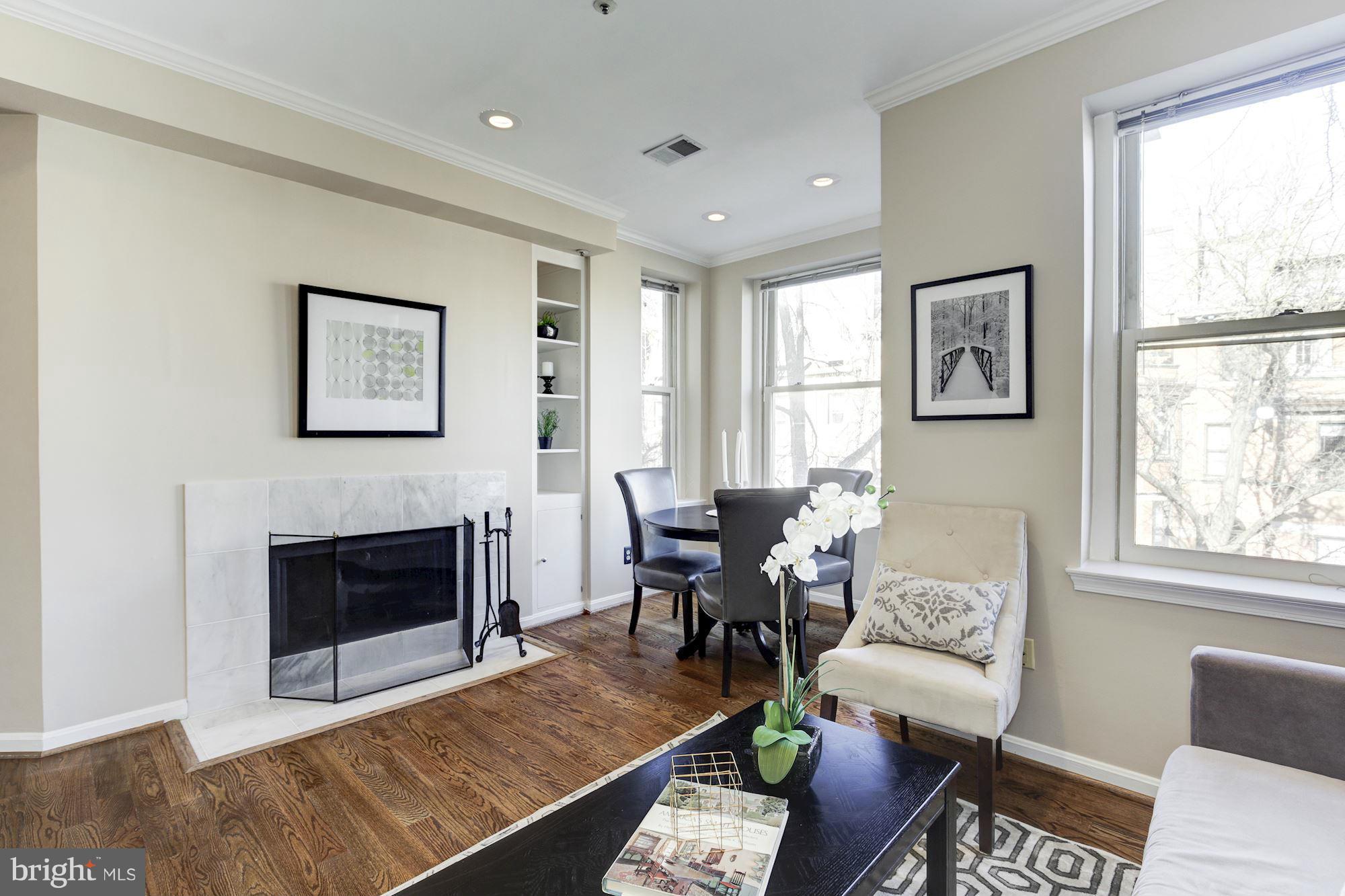 1806 Belmont Road Northwest, Unit 3 Washington, DC 20009 - Photo 5 of 21 a living room with furniture fireplace and window