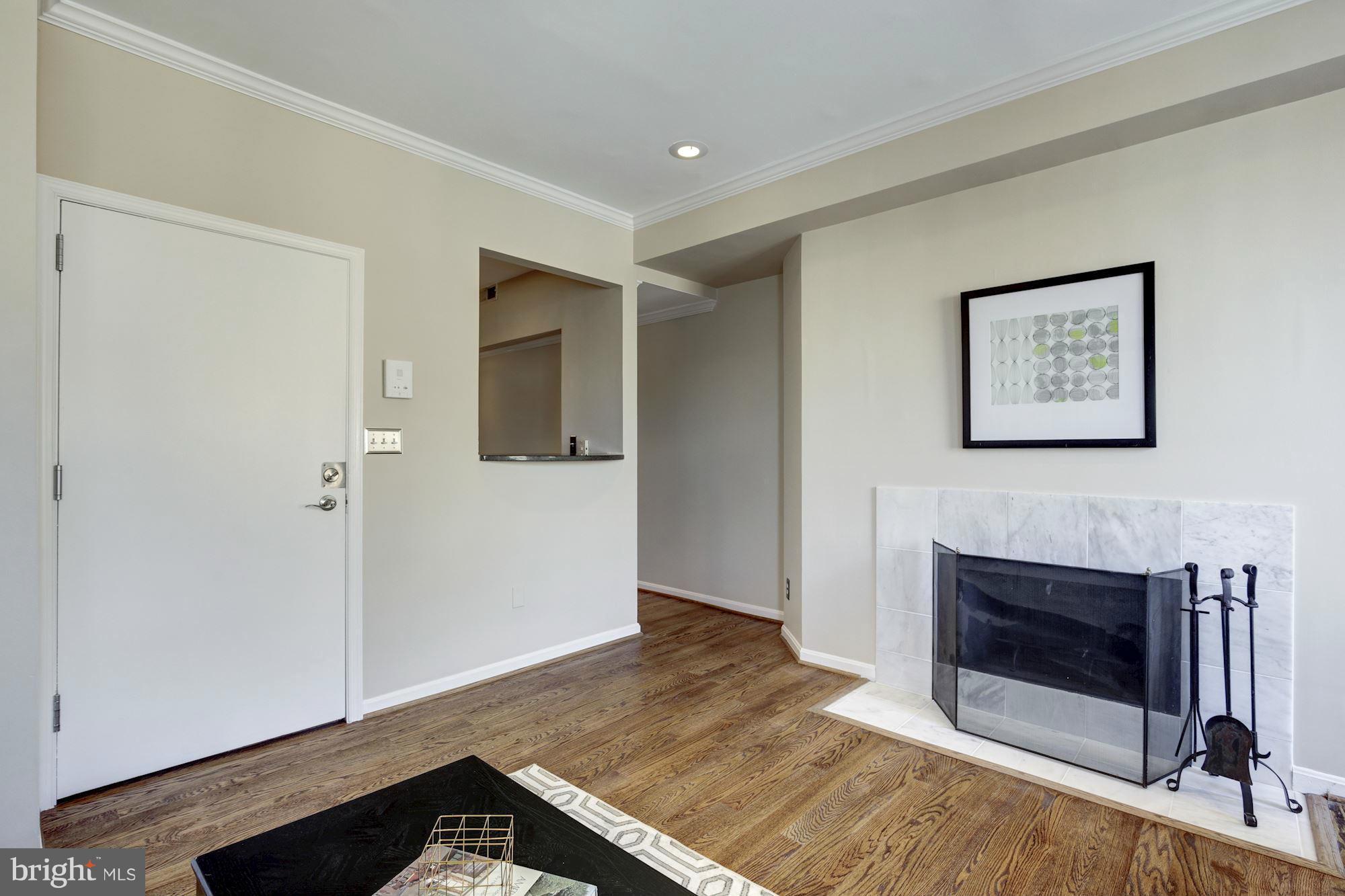 1806 Belmont Road Northwest, Unit 3 Washington, DC 20009 - Photo 6 of 21 a view of a livingroom with an empty space and a fireplace