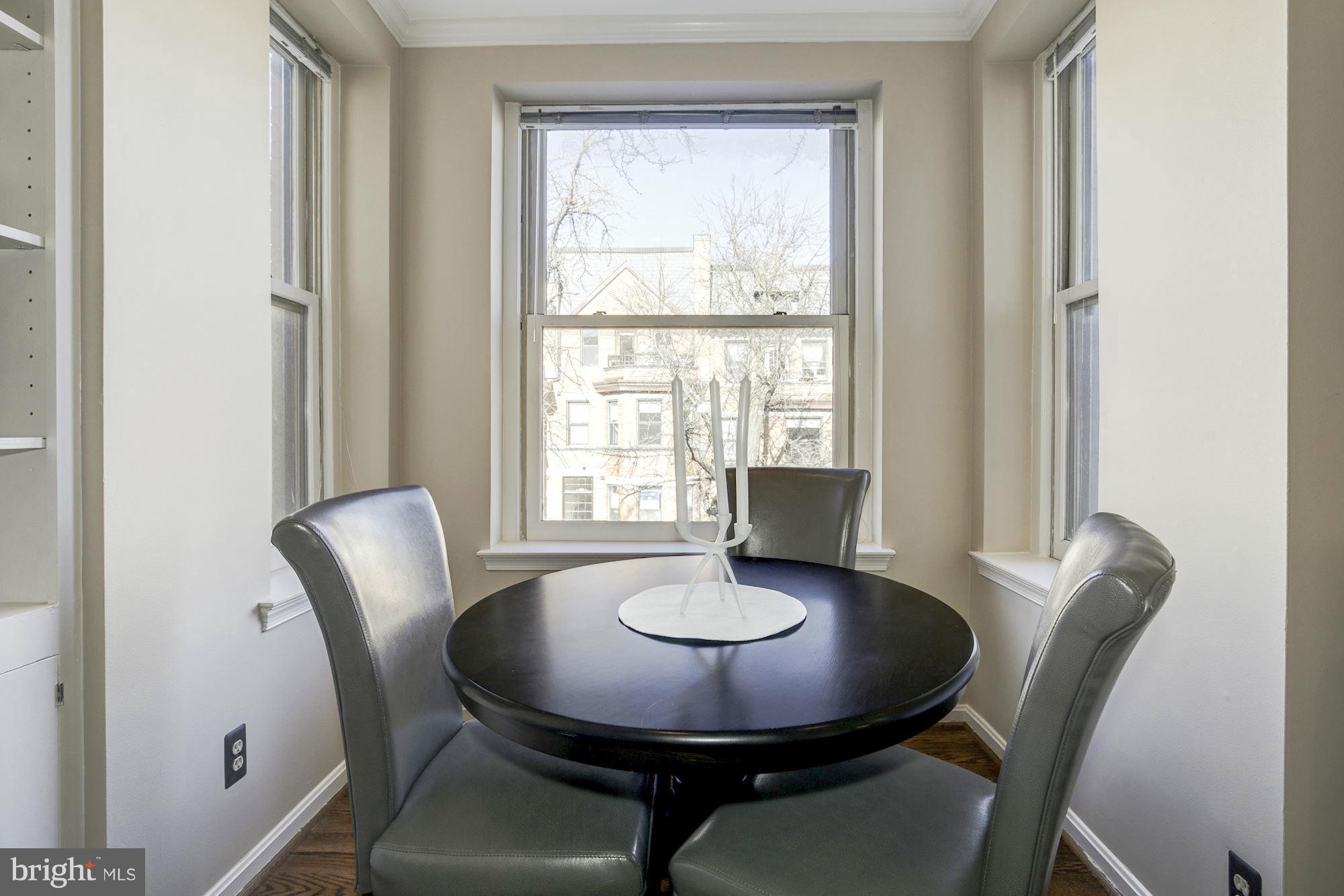 1806 Belmont Road Northwest, Unit 3 Washington, DC 20009 - Photo 7 of 21 a view of a dining room with furniture window and wooden floor