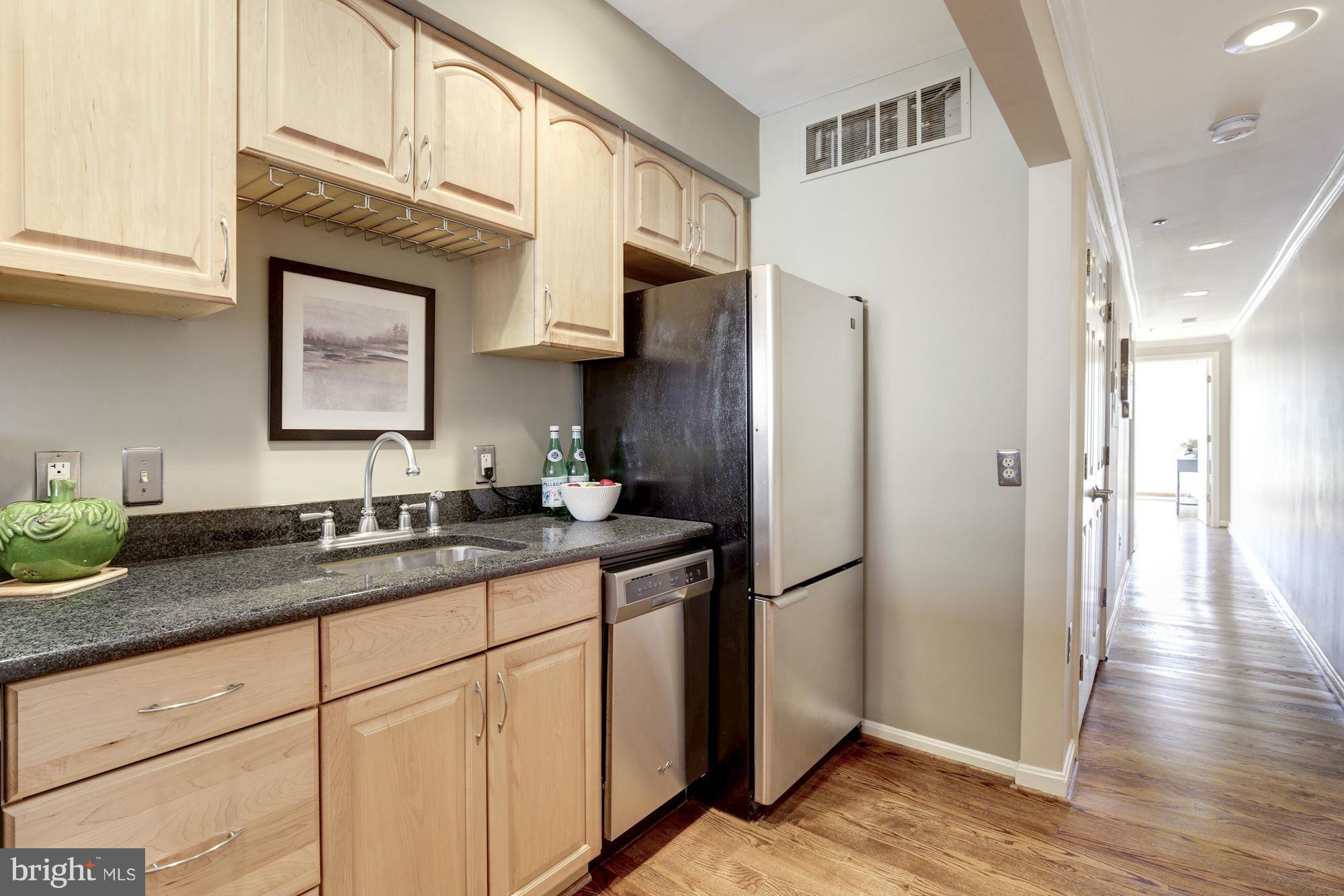 1806 Belmont Road Northwest, Unit 3 Washington, DC 20009 - Photo 9 of 21 a kitchen with stainless steel appliances granite countertop a refrigerator sink and cabinets