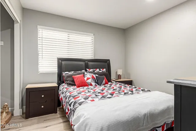 a bedroom with a bed and a potted plant