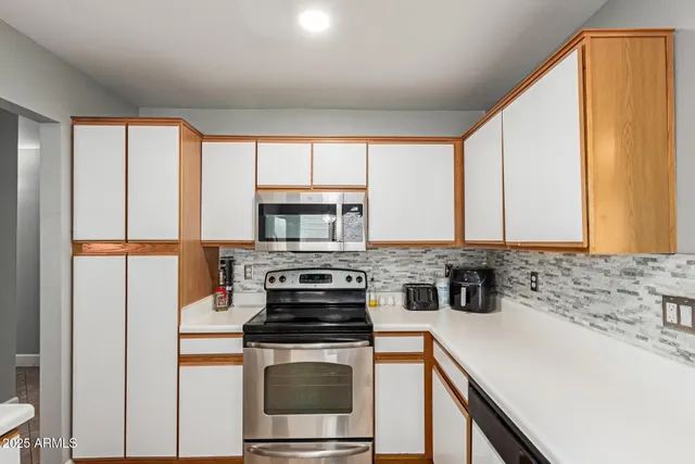a kitchen with a stove a sink and a refrigerator