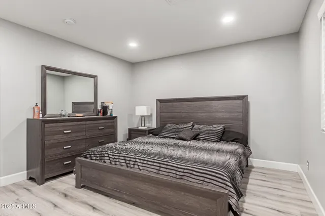 a bedroom with a bed and a dresser