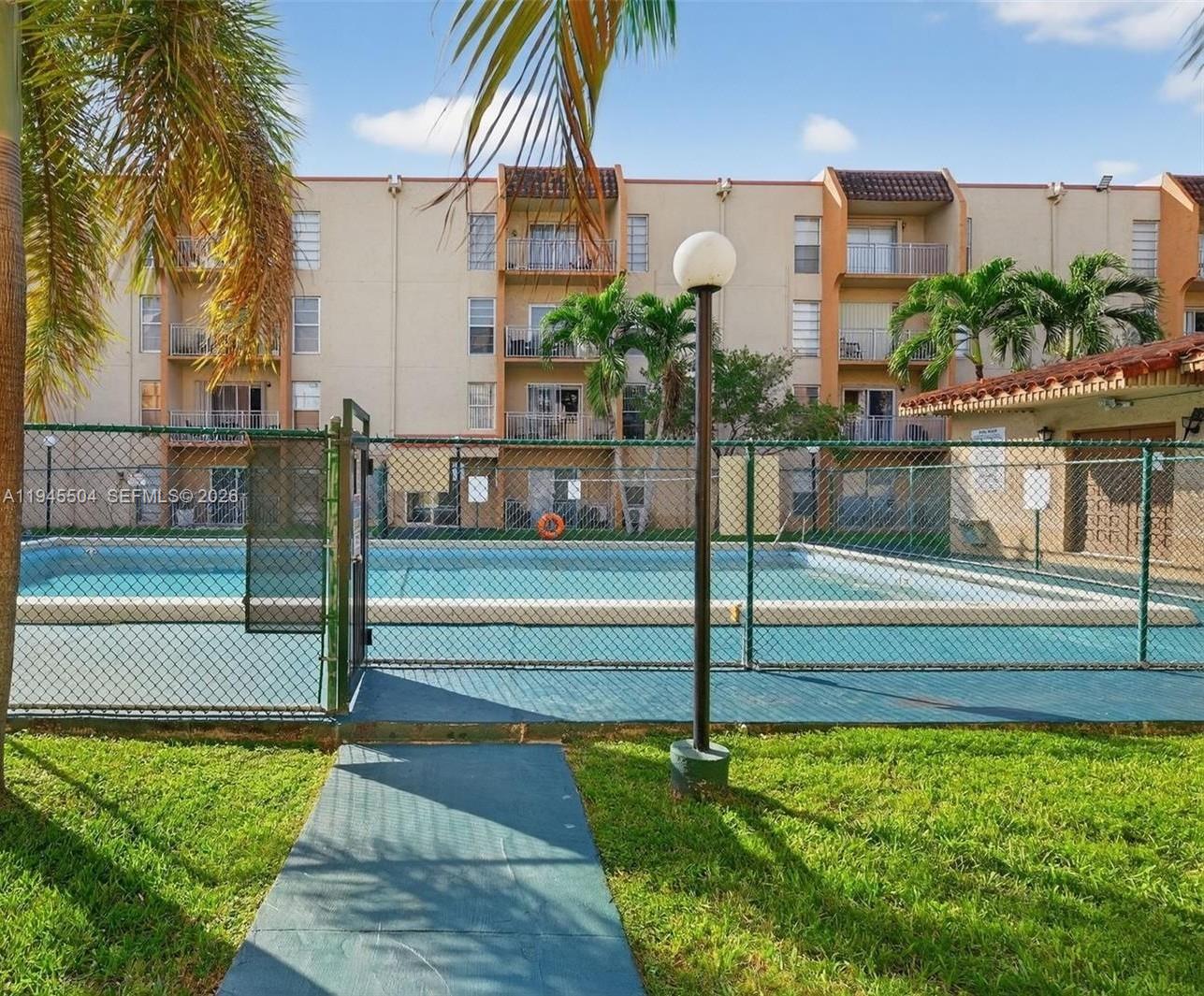 4841 Northwest 7th Street, Unit 2034 Miami, FL 33126 - Photo 3 of 8 a house view with swimming pool