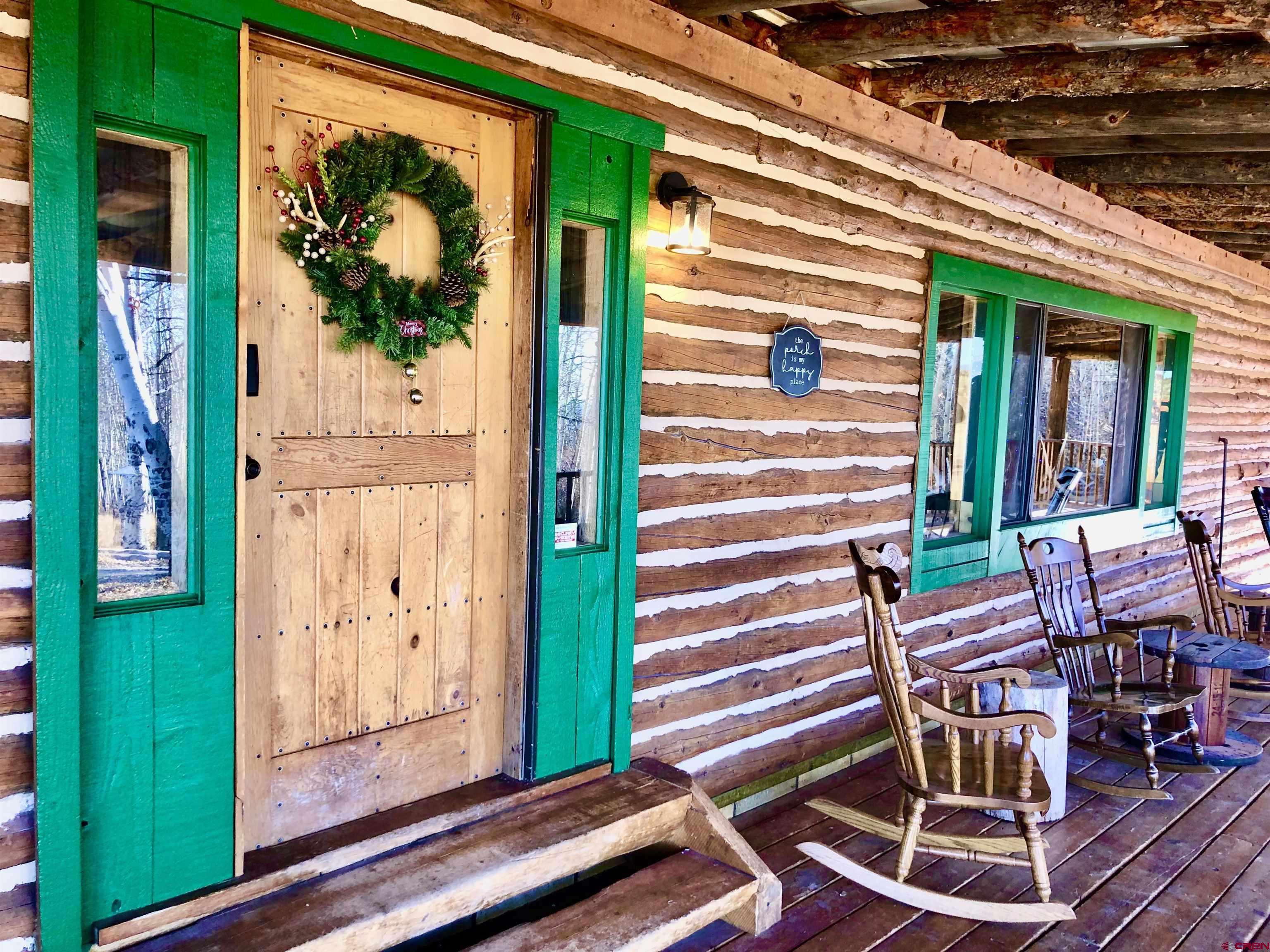 16 Arellano Road, Unit TRES CUERDAS LODGE Amalia, NM 87512 - Photo 15 of 45 a front view of a house with outdoor seating and stairs